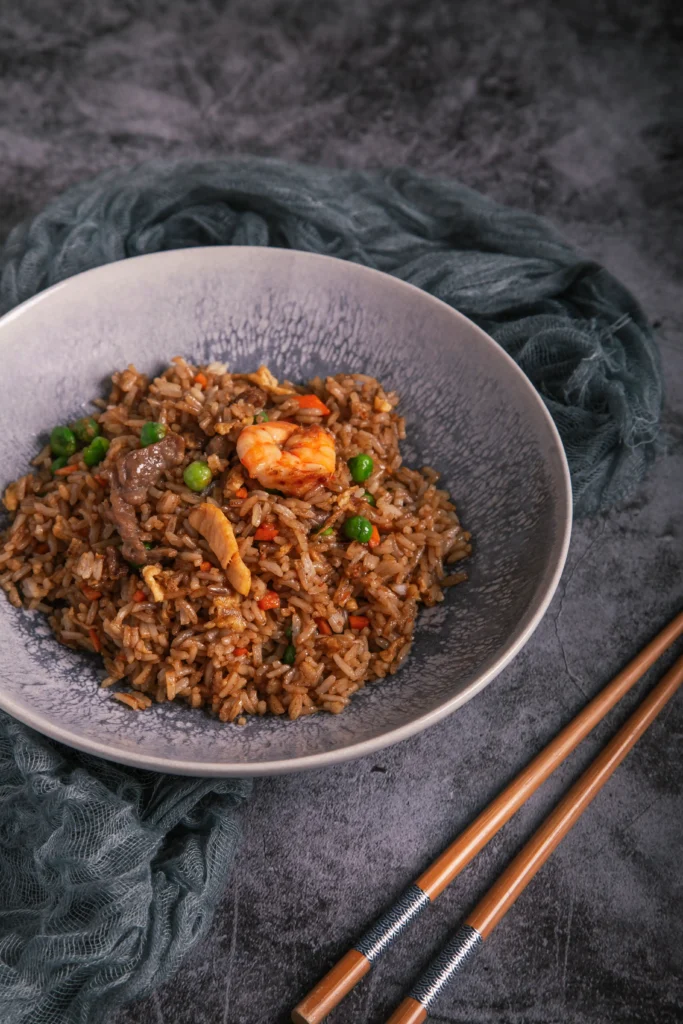 A vibrant plate of Southeast Asian brown rice with stir-fried vegetables.