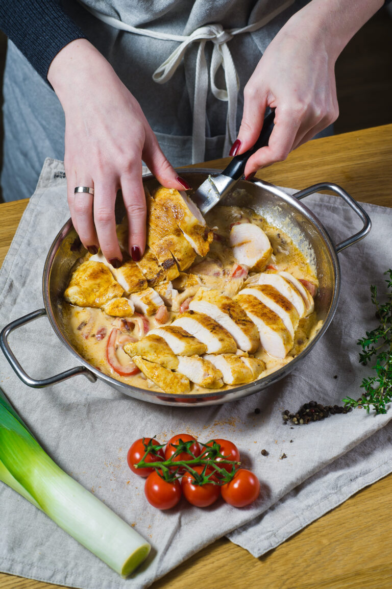 Cooking thin-sliced chicken breast in a skillet.