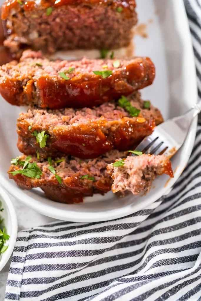 A plate with sliced smoked meatloaf