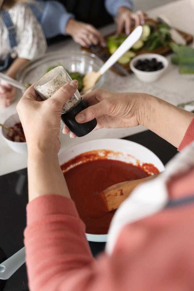 Three bowls of Cajun sauce variations: traditional, creamy, and spicy.