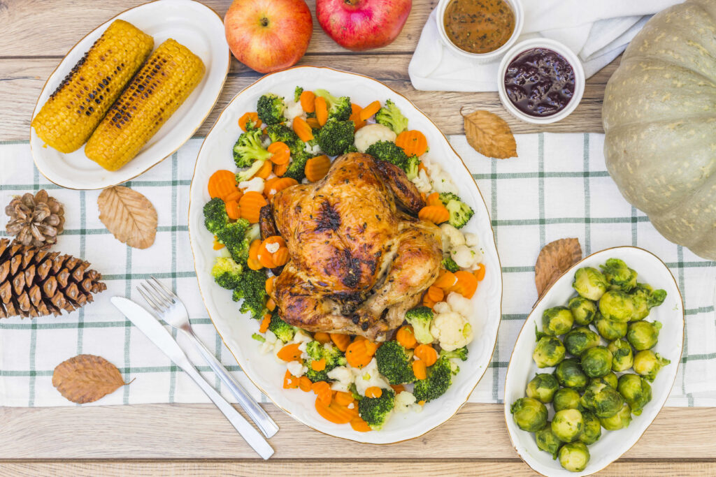 Meal prep containers with rotisserie chicken, roasted vegetables, and rice