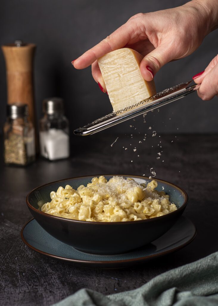 A large pot of boiling pasta with steam rising.