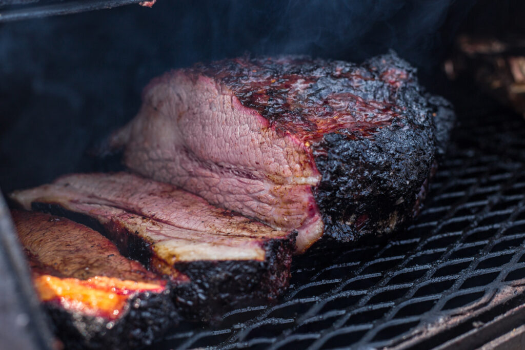 Brisket cooking over a smoker