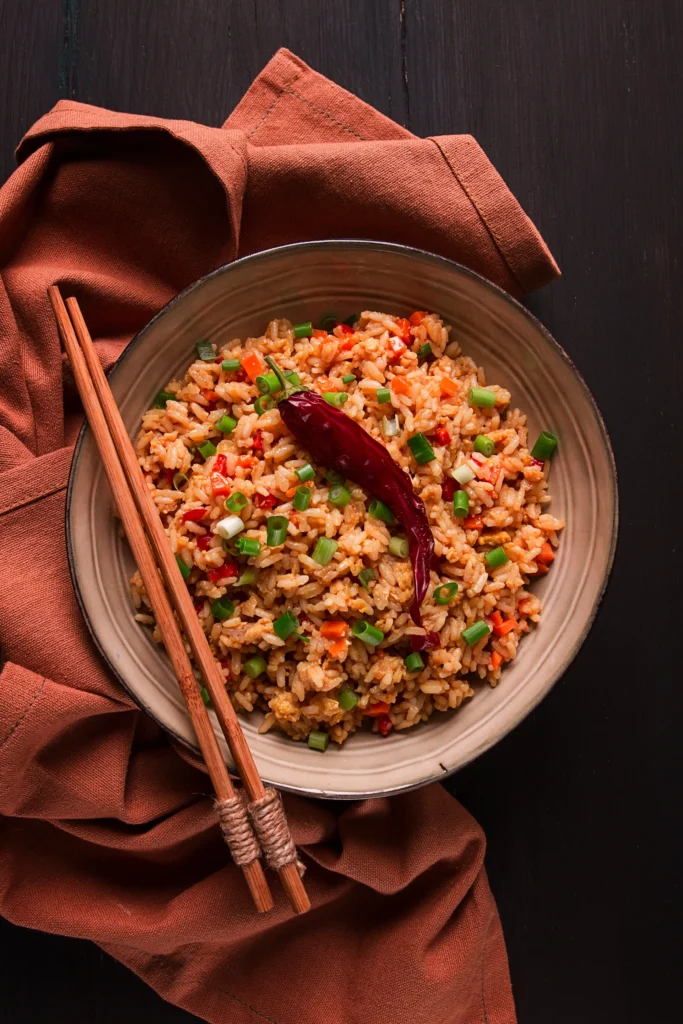 Brown rice with vegetables served with garnishes.