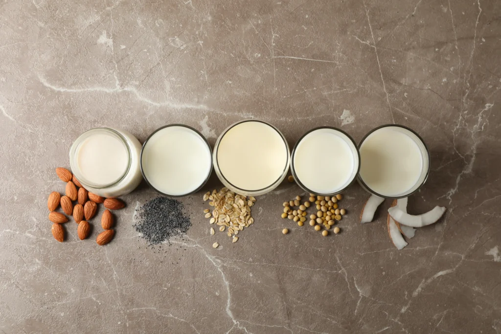 Various milk alternatives like almond milk, soy milk, and broth in small bowls