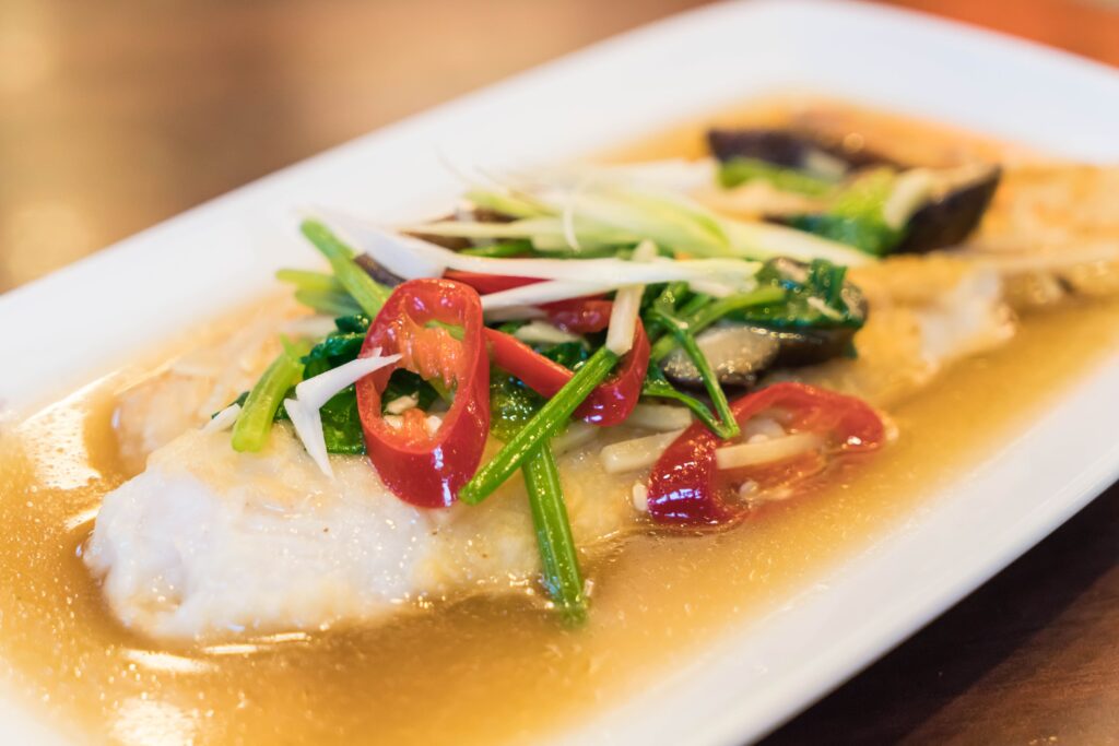 Steamed tilapia fillets with bok choy and ginger.