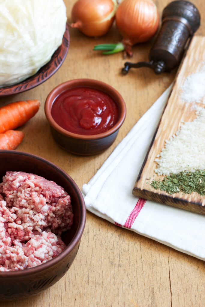 Ingredients for Italian meatloaf, including ground meats, breadcrumbs, and herbs