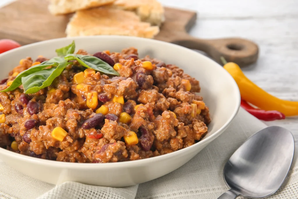 A plated serving of bison chili with cornbread on the side.