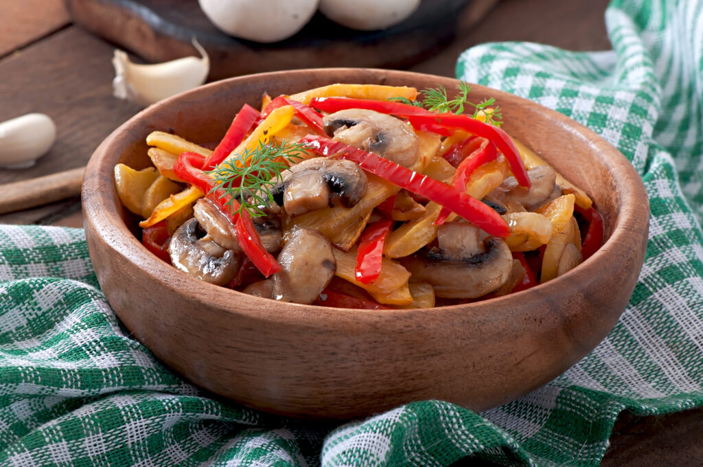 Sautéed mushrooms, spinach, and roasted red peppers in small bowls.