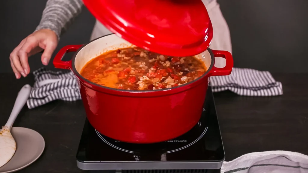 A pot of bison chili simmering on the stovetop