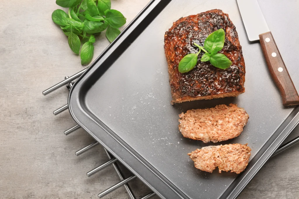 Sliced smoked meatloaf stored in a clear airtight container.