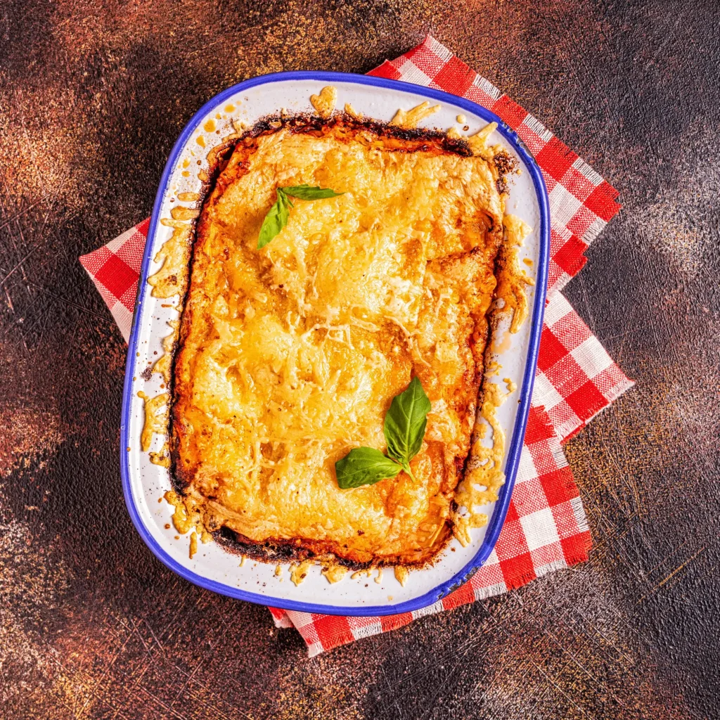 A freshly baked cheesy hamburger potato casserole served in a glass dish.